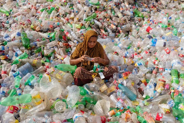 March 13, 2026, Dhaka, Dhaka, Bangladesh: A woman worker sorts used plastic bottles in a recycling factory in Dhaka, Bangladesh. She helps to prevent the bottles from being discarded, sent to landfill, where they can take 1,000 years to biodegrade, or incinerated, which produces toxic fumes. The emission of CO2 and other greenhouse gases will be reduced if recycling takes place in the production of new plastics. This small yet significant act supports environmental sustainability by promoting a responsible cycle of reuse, reducing the strain on natural resources, and safeguarding our ecosystem for future generations. Dhaka Bangladesh - ZUMAs231 20260313_zip_s231_004 Copyright: xJoyxSahax