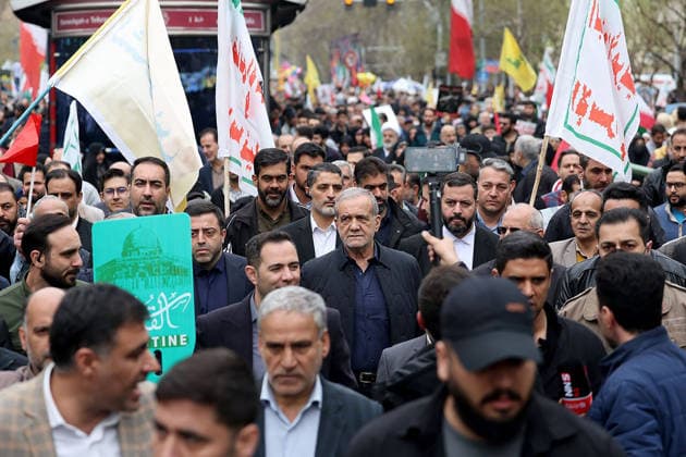 Iranian President Masoud Pezeshkian (C) participates in the traditional Quds Day rally in the capital Tehran, on Friday on March 13, 2026. Thousands of Iranians took to the streets of the capital on Friday to mark Quds Day, an annual event held in support of the Palestinian cause. Established in 1979, Quds Day is traditionally observed on the last Friday of Ramadan.This year s demonstration unfolded against the backdrop of the continuing war between Iran, the United States, and Israel, adding heightened political significance to the occasion.  IRN2026031306 IslamicxRepublicxNewsxAgencyxIRN