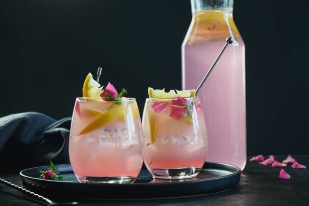 Frisches Getränk oder Limonade mit Zitrone und Rose. Freshness summer rose cocktails with gin and lemon on black background. Close up. (License=RF) Copyright: xZoonar.com SvetlanaxLazhkox 24783287