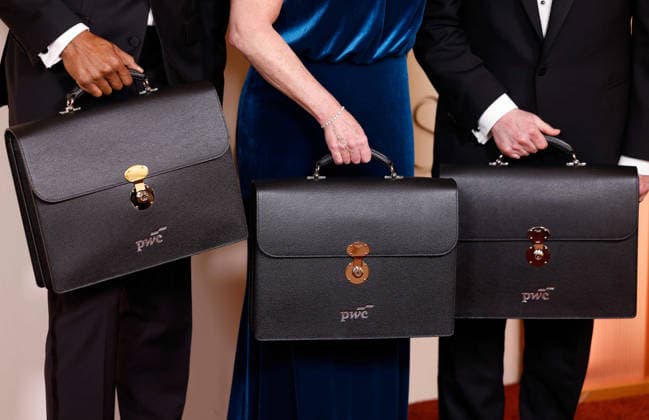 PricewaterhouseCoopers representatives arrive on the red carpet for the 98th annual Academy Awards in the Hollywood section of Los Angeles on Sunday, March 15, 2026. Conan O Brien will host the Oscars for the second consecutive year.  LAP20260315492 JOHNxANGELILLO