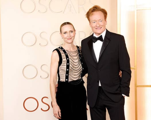 (L-R) Liza Powel O Brien and Conan O Brien arrive on the red carpet for the 98th annual Academy Awards in the Hollywood section of Los Angeles on Sunday, March 15, 2026. Conan O Brien will host the Oscars for the second consecutive year.  LAP20260315517 JOHNxANGELILLO