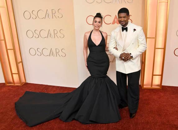 Jennifer Goicoechea and Usher arrive on the red carpet for the 98th annual Academy Awards in the Hollywood section of Los Angeles on Sunday, March 15, 2026. Conan O Brien will host the Oscars for the second consecutive year.  LAP20260315217 JIMxRUYMEN