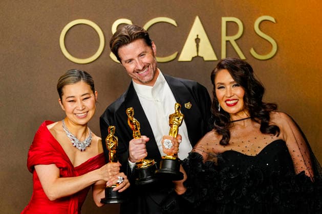 Michelle L.M. Wang, Chris Appelhans, and Maggie King celebrate in the press photo room after winning Best Animated feature Film for KPOP Demon Hunters during the 98th annual Academy Awards in the Hollywood section of Los Angeles on Sunday, March 15, 2026. Conan O Brien is hosting the Oscars for the second consecutive year.  LAP20260315324 BONNIExCASH