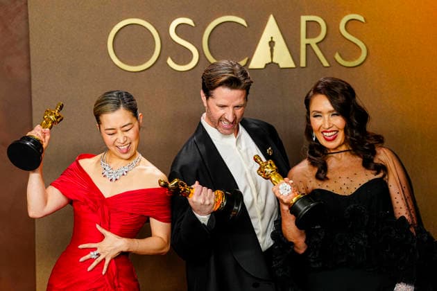 Michelle L.M. Wang, Chris Appelhans, and Maggie King celebrate in the press photo room after winning Best Animated feature Film for KPOP Demon Hunters during the 98th annual Academy Awards in the Hollywood section of Los Angeles on Sunday, March 15, 2026. Conan O Brien is hosting the Oscars for the second consecutive year.  LAP20260315323 BONNIExCASH