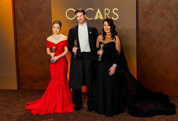 Michelle L.M. Wang, Chris Appelhans, and Maggie King celebrate in the press photo room after winning Best Animated feature Film for KPOP Demon Hunters during the 98th annual Academy Awards in the Hollywood section of Los Angeles on Sunday, March 15, 2026. Conan O Brien is hosting the Oscars for the second consecutive year.  LAP20260315329 BONNIExCASH