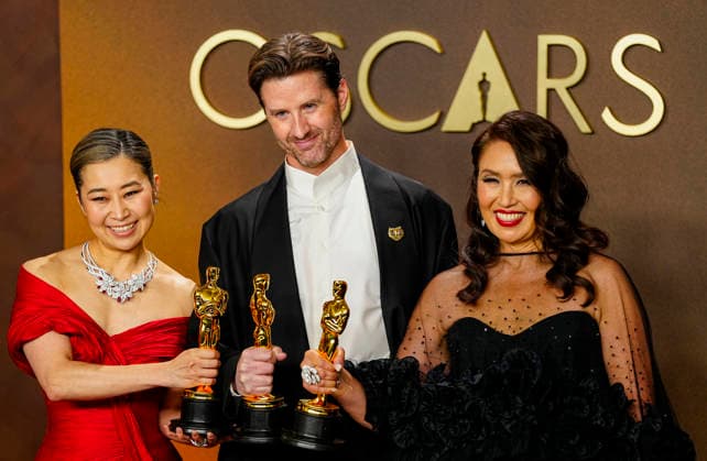 Michelle L.M. Wang, Chris Appelhans, and Maggie King celebrate in the press photo room after winning Best Animated feature Film for KPOP Demon Hunters during the 98th annual Academy Awards in the Hollywood section of Los Angeles on Sunday, March 15, 2026. Conan O Brien is hosting the Oscars for the second consecutive year.  LAP20260315330 BONNIExCASH