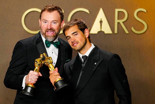 Sam A. Davis and Jack Piatt celebrate in the press photo room after winning the best Live Action Short Film Oscar for The Singers during the 98th annual Academy Awards in the Hollywood section of Los Angeles on Sunday, March 15, 2026. Conan O Brien is hosting the Oscars for the second consecutive year.  LAP202603152311 BONNIExCASH