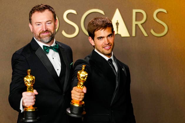 Sam A. Davis and Jack Piatt celebrate in the press photo room after winning the best Live Action Short Film Oscar for The Singers during the 98th annual Academy Awards in the Hollywood section of Los Angeles on Sunday, March 15, 2026. Conan O Brien is hosting the Oscars for the second consecutive year.  LAP202603152312 BONNIExCASH