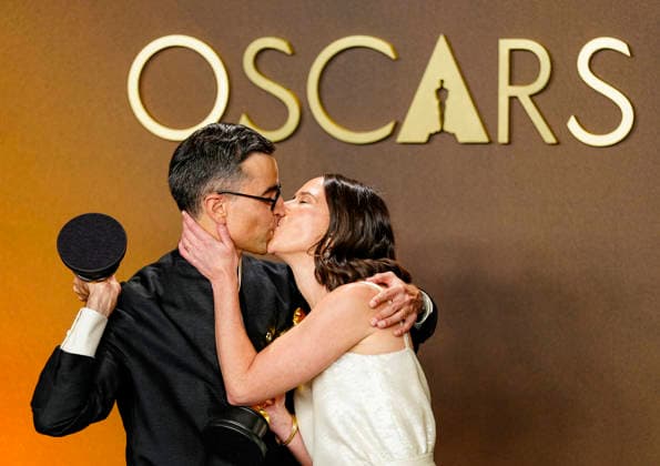 Natalie Musteata and Alexander Singh exchange a kiss during celebrations in the press photo room after winning the Best Live Action Short Film Oscar for Two People Exchanging Saliva during the 98th annual Academy Awards in the Hollywood section of Los Angeles on Sunday, March 15, 2026. Conan O Brien is hosting the Oscars for the second consecutive year.  LAP20260315350 BONNIExCASH