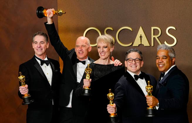 Gareth John, Al Nelson, Gwendolyn Yates Whittle, Gary A. Rizzo, and Juan Peralta celebrate in the press photo room after winning the Best Sound Oscar for F1 during the 98th annual Academy Awards in the Hollywood section of Los Angeles on Sunday, March 15, 2026.  LAP20260315382 BONNIExCASH