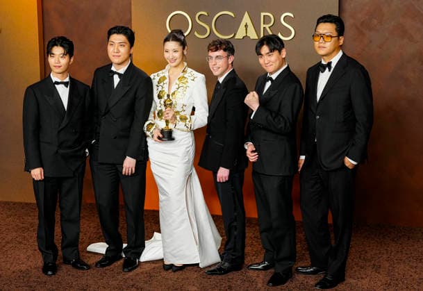 EJAE, Mark Sonnenblick, Joong Gyu Kwak, Yu Han Lee, Hee Dong Nam, Jeong Hoon Seo, and Teddy Park celebrate in the press photo room after winning the Best Original Song Oscar for Golden from KPop Demon Hunters during the 98th annual Academy Awards in the Hollywood section of Los Angeles on Sunday, March 15, 2026.  LAP20260315393 BONNIExCASH