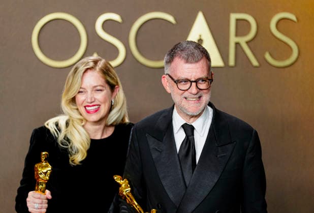 Paul Thomas Anderson and Sarah Murphy celebrate in the press photo room after winning the Best Picture Oscar for One Battle After Another during the 98th annual Academy Awards in the Hollywood section of Los Angeles on Sunday, March 15, 2026.  LAP2026031540737 BONNIExCASH