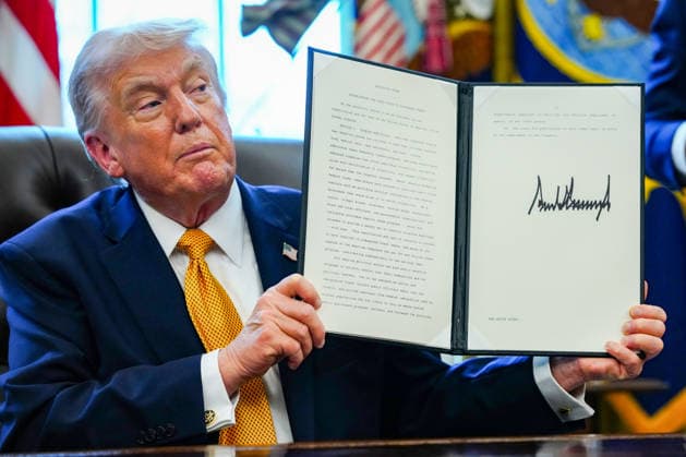 President Donald Trump holds a signed executive order in the Oval Office of the White House in Washington, DC on Monday, March 16, 2026. The order will formally launch a task force, led by Vice President JD Vance, to investigate fraud nationwide.  WAP20260316342 AARONxSCHWARTZ