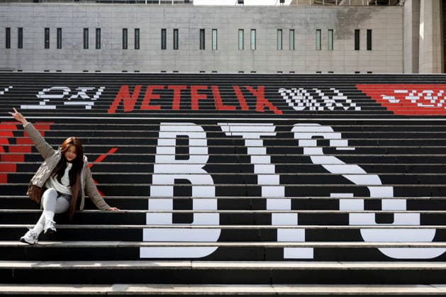 Fans of the K-pop group BTS pose for commemorative photos decorated with promotional material for the upcoming BTS concert in Seoul, South Korea, March 18, 2026. BTS is scheduled to perform their comeback concert, BTS THE COMEBACK LIVE: ARIRANG, at Gwanghwamun Square on March 21, 2026. Matrix Images Jung Ui-Chel 