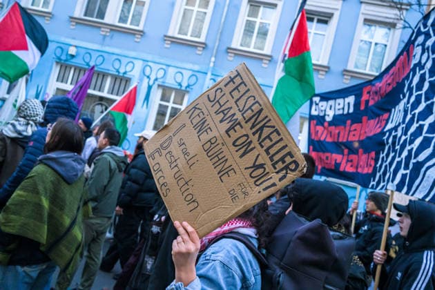March 19, 2026, Berlin, Berlin, Germany: One of the protesters holding a placard along the rest protestors, during the protest against IDF spokesman s talk on Wednesday Mar. 18 2026 in Leipzig, Germany. Pro-Palestine supporters protested against the talk given by the IDF Spokesman and reservist, Arye Sharuz Shalicar, as part of the Festival Leipzig Liest (Leipzig Reads). At the event venue they were met by a small number of Israel supporters. Berlin Germany - ZUMAk201 20260319_zip_k201_002 Copyright: xNikosxKanistrasx