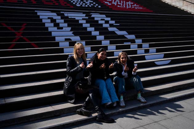 March 19, 2026, Seoul, South Korea: Tourists pose for pictures at a staircase near the venue for the comeback concert of the K-pop boy band BTS in Gwanghwamun Square on Thursday, March 19, 2026 in Seoul, South Korea. All seven members of BTS, which has been on hiatus since 2022 due to compulsory military service, are returning in a free concert on March 21, 2026 for their upcoming new album ARIRANG. Seoul South Korea - ZUMAh163 20260319_znp_h163_027 Copyright: xJintakxHanx