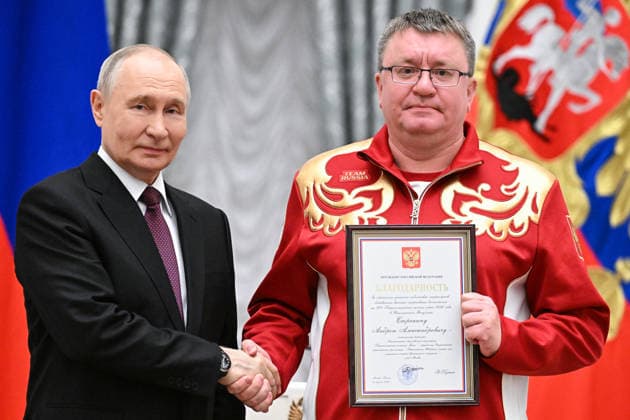 Russia Putin Paralympic Athletes 9127041 19.03.2026 Russian President Vladimir Putin awards Secretary General of the Russian Paralympic Committee, President of the All-Russian Federation of Sports for Persons with Physical Impairments, five-time Paralympic Champion Andrey Strokin with the certificate of appreciation during a state awards ceremony for the Russian medalists of the Milano Cortina 2026 Paralympic Winter Games at the Kremlin in Moscow, Russia. Sergey Bobylev Sputnik Moscow Russia  Copyright: xSergeyxBobylevx
