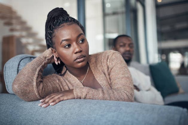 Thinking, black couple or woman in lounge with fighting, argument or frustration in relationship issue. Reflection, anger or people in house with tension, partner disagreement or conflict in marriage. model released property released Copyright: xwww.peopleimages.comx