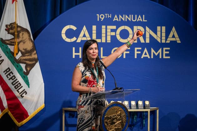 March 19, 2026, Sacramento, Ca, USA: Kimiko Burton, daughter of former legislator John L. Burton, holds a small container of his ashes during the induction of the 19th class to the California Hall of Fame at the California Museum on Thursday, March 19, 2026, in Sacramento. Sacramento USA - ZUMAj89_ 20260319_zaf_j89_009 Copyright: xPaulxKitagakixJr.x