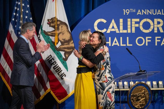 March 19, 2026, Sacramento, Ca, USA: First Partner Jennifer Siebel Newsom hugs Kimiko Burton, daughter of former legislator John L. Burton, alongside Gov. Gavin Newsom during the induction of the 19th class to the California Hall of Fame at the California Museum on Thursday, March 19, 2026, in Sacramento. Sacramento USA - ZUMAj89_ 20260319_zaf_j89_010 Copyright: xPaulxKitagakixJr.x