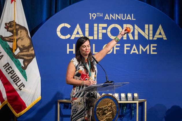 March 19, 2026, Sacramento, Ca, USA: Gov. Gavin Newsom places a medal on Kimiko Burton, daughter of former legislator John L. Burton, alongside First Partner Jennifer Siebel Newsom during the induction of the 19th class to the California Hall of Fame at the California Museum on Thursday, March 19, 2026, in Sacramento. Sacramento USA - ZUMAj89_ 20260319_zaf_j89_011 Copyright: xPaulxKitagakixJr.x