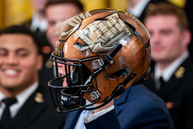 President Donald Trump holds a Navy Midshipmen football helmet during the Commander in Chief s Trophy ceremony in the East Room of the White House in Washington, DC on Friday, March 20, 2026. The award is presented annually to the winner of the football competition between the Navy, Air Force and Army. Navy has won the trophy back to back years and 13 times over the last 23 years.  WAP202603201166 BONNIExCASH