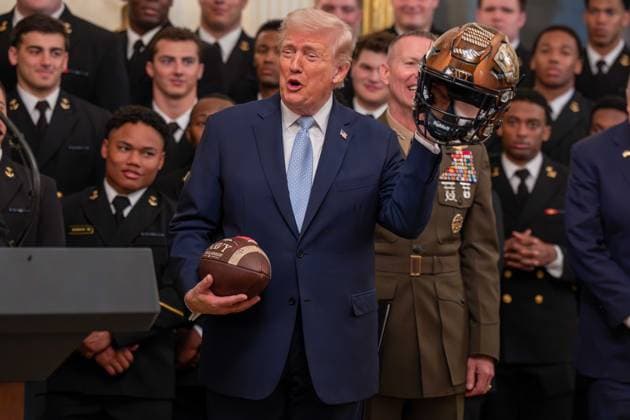 March 20, 2026, Washington, District Of Columbia, USA: President DONALD TRUMP is presented with gifts by Navy Midshipmen players BLAKE HORVATH and LANDON ROBINSON during an event in the East Room of the White House. Washington USA - ZUMAs365 20260320_znp_s365_028 Copyright: xJoeyxSussmanx
