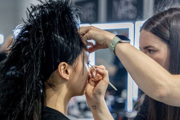 Fely Campos fashion show at Mercedes Benz Fashion Week Make-up artist applies make-up to a model backstage at Fely Campos fashion show on the occasion of Mercedes Benz Fashion Week, March 21, 2026, in Madrid Spain Fely Campo is a firm that stands out for the precision of its patterns and its refined style Its fashion show is part of the Mercedes Benz Fashion Week Madrid, the main Spanish fashion show organized by IFEMA, which brings together established firms and new talent MARCH 21, 2026 FASHION Madrid Madrid Spain  Copyright: xRicardoxRubiox 7384955