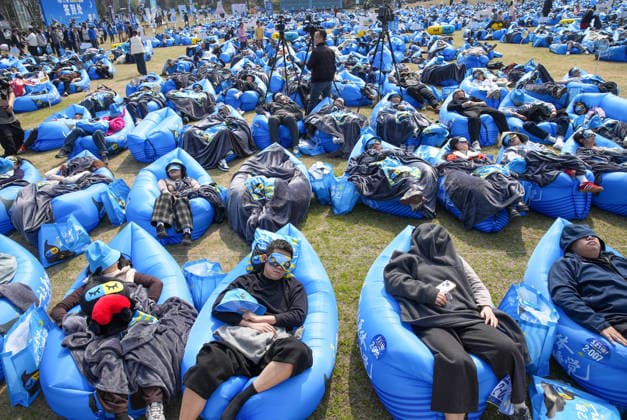 DEQING, CHINA - MARCH 21: Participants fall asleep on the outdoor lawn in the Sleep King challenge to mark World Sleep Day on March 21, 2026 in Deqing County, Huzhou City, Zhejiang Province of China.  Copyright: xVCGx 111629755092
