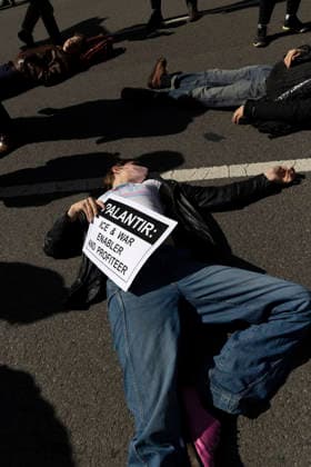 March 21, 2026, New York, New York, USA: Demonstrators with ACT UP (AIDS Coalition To Unleash Power) march from the AIDS Memorial in Greenwich Village to PalantirÃ¢â‚¬â ¢s offices in Chelsea where they stage a die-in in the street denouncing the companyÃ¢â‚¬â ¢s war profiteering. ACT UP NY marks its 39th anniversary of fighting the AIDS epidemic with a rally and street demonstration honoring AIDS and healthcare activist Mark Milano and protesting the Trump administrationÃ¢â‚¬â ¢s slashing of HIV AIDS funding while increasing budgets for ICE and the war on Iran. A sign reads PALANTIR ICE and WAR ENABLER AND PROFITEER. New York USA - ZUMAr174 20260321_znp_r174_007 Copyright: xGinaxMxRandazzox
