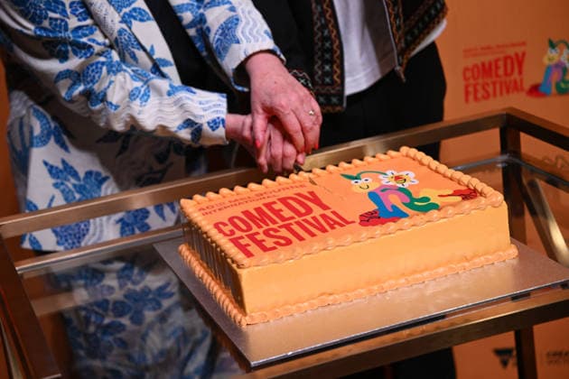 MELBOURNE COMEDY FESTIVAL LAUNCH, A Melbourne Comedy Festival cake is cut during the launch of the 2026 Melbourne International Comedy Festival at Melbourne Town Hall, in Melbourne, Monday, March 23, 2026. ( NO ARCHIVING MELBOURNE VICTORIA AUSTRALIA  Copyright: xJAMESxROSSx 20260323170164154180