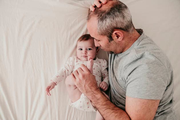 Father and baby bonding at home on bed in morning model released, Symbolfoto property released, EBBF09333