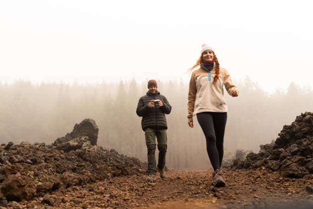 Hiker couple walking on volcanic trail in foggy forest outdoors model released, Symbolfoto, AFVF09435