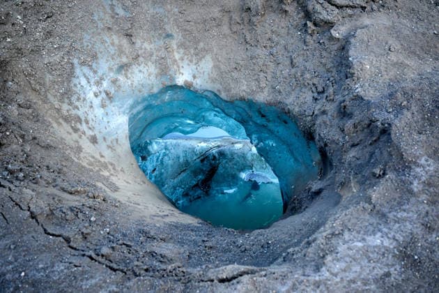 Creative Highlights World Glacier ice cave opening with vivid blue colors Hvolsvöllur, Rangárþing eystra, Iceland R_OSBJ260316C-1947288-01