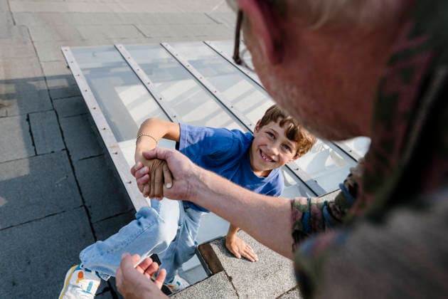 Father helping son on rooftop of house in daylight model released, Symbolfoto property released, KNSF12282