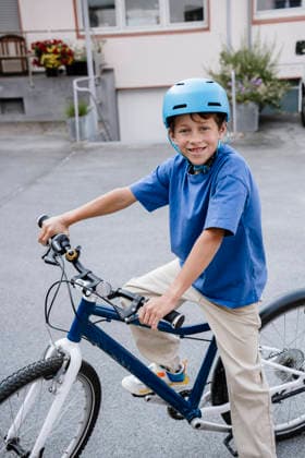 Happy child outdoors riding bike with helmet smiling model released, Symbolfoto property released, KNSF12346