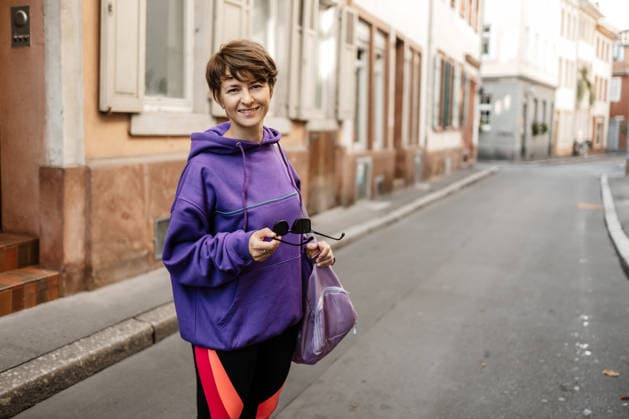 Woman in sportswear smiling on a street in Heidelberg Germany model released, Symbolfoto, MCHF00725