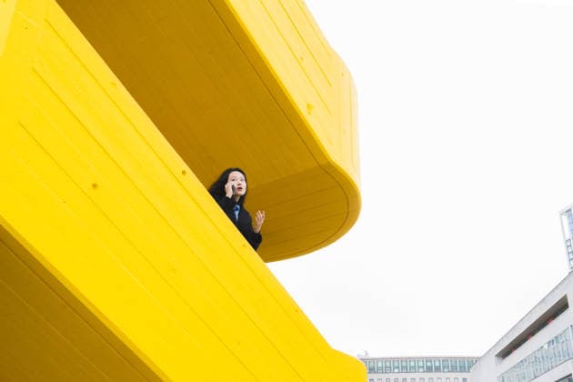 Woman talking on mobile phone on yellow modern building balcony model released, Symbolfoto, PLF00118