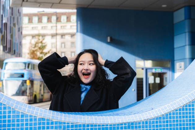 Excited woman expressing joy outdoors in urban city setting model released, Symbolfoto, PLF00140