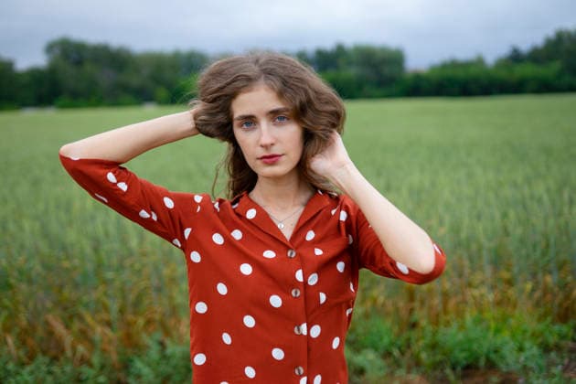 Woman in red polka dot blouse smiling in wheat field during summer model released, Symbolfoto, VCF01461