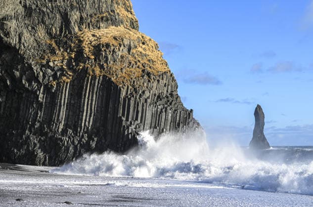 Creative Highlights World Nature’s Geological Archive: Iceland VIK, ICELAND - MARCH 11: Waves hit the black sand beach along Iceland’s southern coast, with a sea stack rising off the shoreline in Iceland on March 11, 2026. Iceland, located along the boundary between the Eurasian and North American tectonic plates and often described as the Land of Fire and Ice, is known for its volcanic activity and glacial landscapes. The island nation in the North Atlantic stands out for its dynamic terrain shaped by intense volcanic activity and glacial formations, offering significant opportunities for both scientific research and nature tourism. Black sand beaches formed by lava meeting the ocean, along with basalt columns, sea caves and isolated rock formations rising off th  Copyright: x2026xAnadoluxAytuÄüxCanxSencarx