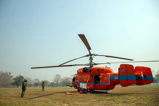 March 27, 2026, Chiang Mai, Thailand: A KA-32 helicopter from the Department of Disaster Prevention and Mitigation is prepared for aerial firefighting operations in Chiang Mai, northern Thailand, as crew members carry out checks and equipment setup while authorities respond to ongoing wildfires and rising PM2.5 air pollution. Chiang Mai Thailand  - ZUMAs197 20260327_aaa_s197_311 Copyright: xPongmanatxTasirix