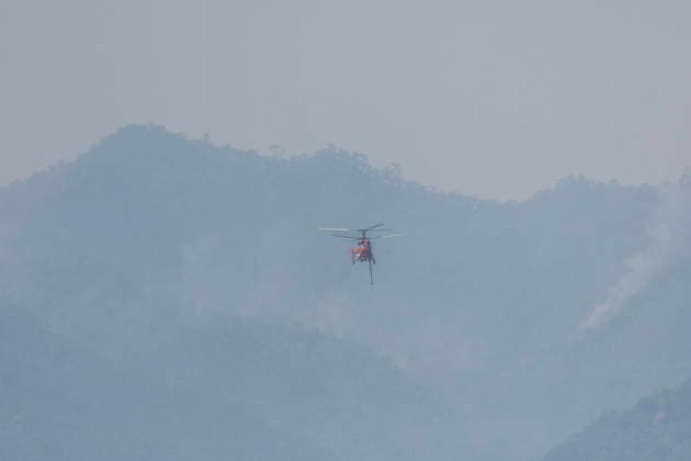 March 27, 2026, Chiang Mai, Thailand: A KA-32 helicopter from the Department of Disaster Prevention and Mitigation conducts aerial firefighting operations over mountainous forest areas in Chiang Mai, northern Thailand, carrying a water bucket while flying through smoke-filled valleys as authorities battle ongoing wildfires and severe PM2.5 air pollution. Chiang Mai Thailand - ZUMAs197 20260327_aaa_s197_358 Copyright: xPongmanatxTasirix