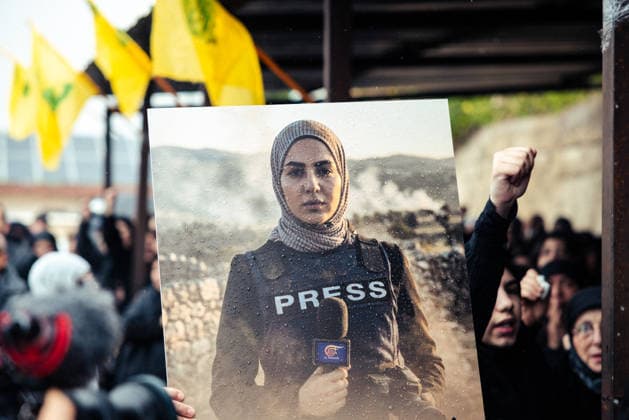 Journalists funeral Beirut Lebanon A mourner holds up a picture of slain journalist, Fatima Ftouni, during the funeral of journalists killed the previous day in an Israeli strike in south Lebanon in the Choueifat area on the outskirts of Beirut, on March 29, 2026. An Israeli strike killed three journalists on March 28 in south Lebanon, including a well-known reporter for Hezbollah s Al Manar network, with Lebanese authorities denouncing the attack as a war crime . Choueifat Mount Lebanon Lebanon Copyright: xJonathanxLabuschx
