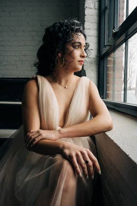 Woman in evening gown contemplating view through window Amesbury, Massachusetts, United States CR_FKNH260328A2-1970313-01 ,model released, Symbolfoto