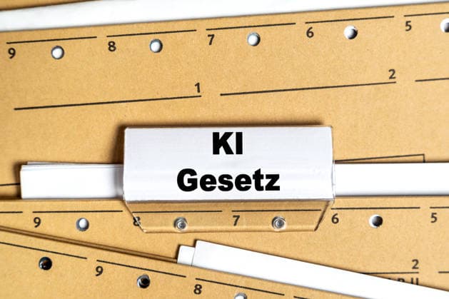 Bavaria, Germany - March 31, 2026: PHOTOMONTAGE, file folder with the inscription: AI law, symbolic image for legal regulations and regulation of artificial intelligence *** FOTOMONTAGE, Aktenordner mit der Aufschrift: KI Gesetz, Symbolbild für gesetzliche Regelungen und Regulierung von künstlicher Intelligenz