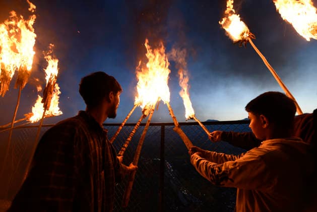 April 2, 2026, Srinagar, Jammu And Kashmir, India: Kashmiri men hold a lit torches outside the cave shrine of Sakhi Zain-ud-din Wali, a Sufi saint, during an annual torch festival in Aishmuqam, 75 km (47 miles) south of Srinagar. Thousands of Muslim villagers in Kashmir gathered at a 15th-century Sufi saint s hilltop shrine for the annual torch festival, also known as the Zool Festival. Devotees lit wooden torches to honour the revered saint, marking the end of winter and the beginning of the paddy sowing season. Many believe this traditional torch festival commemorates the saint s victory over a demon that once terrorized local villagers. Flames illuminated the forested hillside as people paid obeisance at the mausoleum and took part in fe - ZUMAz120 20260402_zip_z120_020 Copyright: xBasitxZargarx