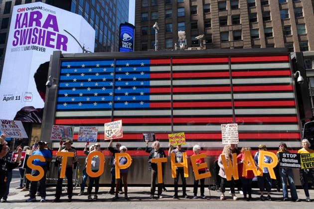 April 4, 2026, New York, New York, USA: Demonstrators join Rise and ResistÃ¢â‚¬â ¢s anti-war protest under the Times Square US Army Recruiting Station American flag, calling for an end to the war on Iran and denouncing President Trump and Secretary of Defense Hegseth as war criminals. Protesters chant holding letters that spell out Ã¢â‚¬ËœSTOP THE WAR,Ã¢â‚¬â ¢ and signs that read NOPE TO YOUR FAUX KING WARS NO WAR ON IRAN STOP Christian Nationalists. New York USA - ZUMAr174 20260404_znp_r174_016 Copyright: xGinaxMxRandazzox