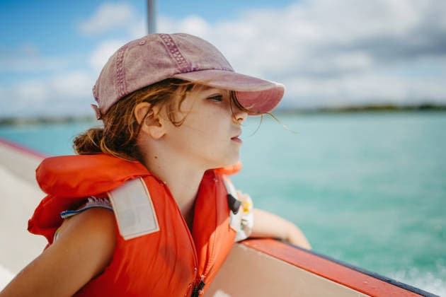 Girl on boat during tropical family vacation. Girl on boat during tropical family vacation in Mauritius. model released