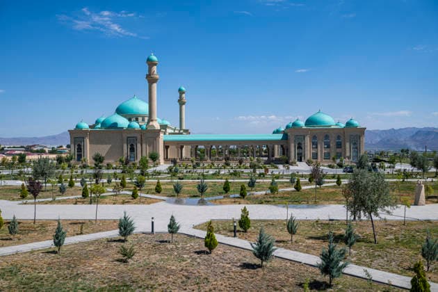 Explore Haydar Mosque in Nakhchivan and its large garden in Azerbaijan with clear skies and mountains in the background Copyright: MichaelxRunkel 1184-15777